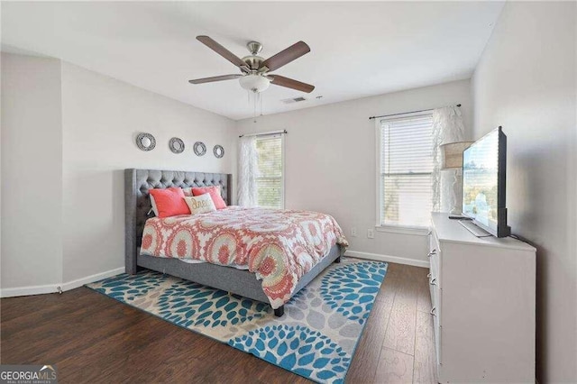 bedroom featuring ceiling fan and dark wood-type flooring