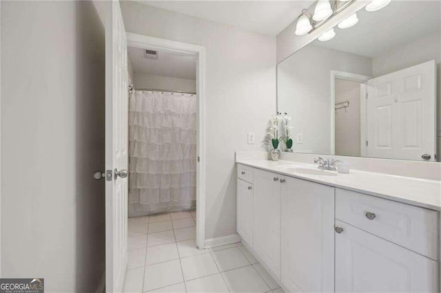 bathroom with tile patterned floors and vanity