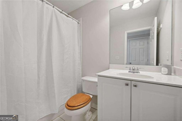 bathroom with tile patterned floors, vanity, and toilet