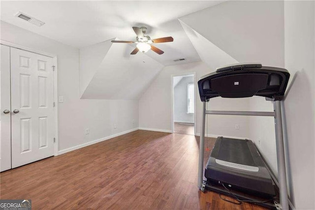 workout area featuring ceiling fan, wood-type flooring, and lofted ceiling