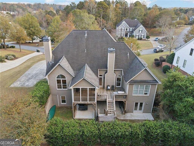 back of property with a patio, a sunroom, and a wooden deck