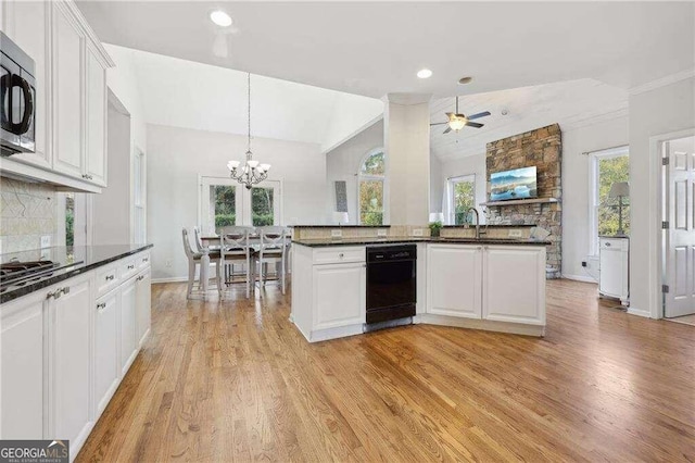 kitchen featuring decorative backsplash, vaulted ceiling, light hardwood / wood-style floors, and white cabinetry