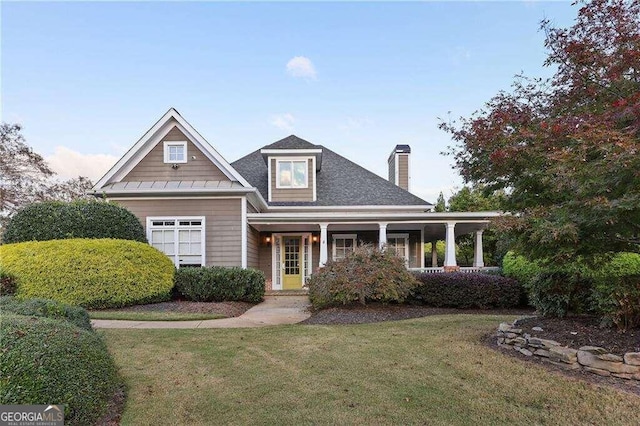 view of front of home with covered porch and a front yard