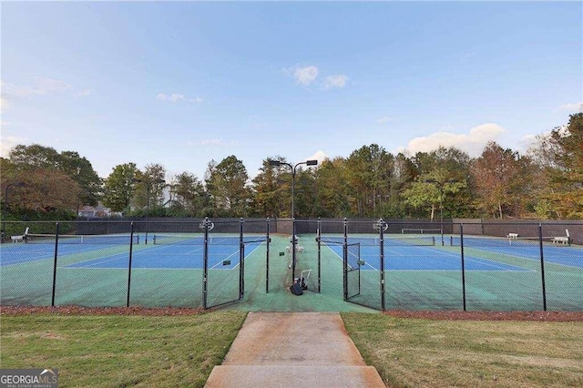 view of sport court with a yard