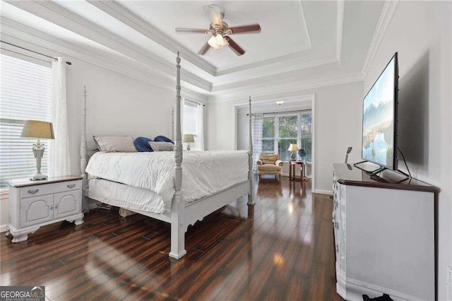 bedroom featuring ceiling fan, dark hardwood / wood-style floors, a raised ceiling, and crown molding