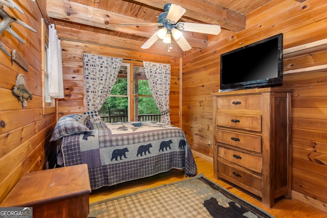 bedroom with hardwood / wood-style floors, ceiling fan, wooden walls, and wood ceiling