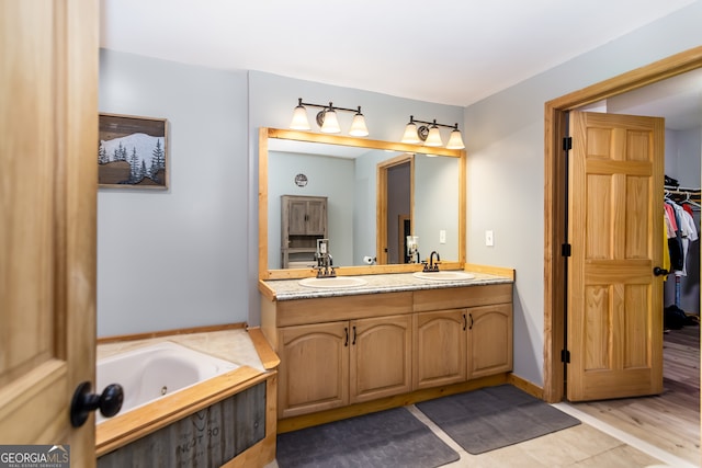 bathroom featuring vanity, hardwood / wood-style flooring, and a tub to relax in