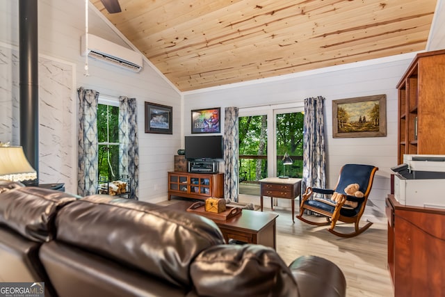 living room with light hardwood / wood-style floors, plenty of natural light, wooden walls, and vaulted ceiling