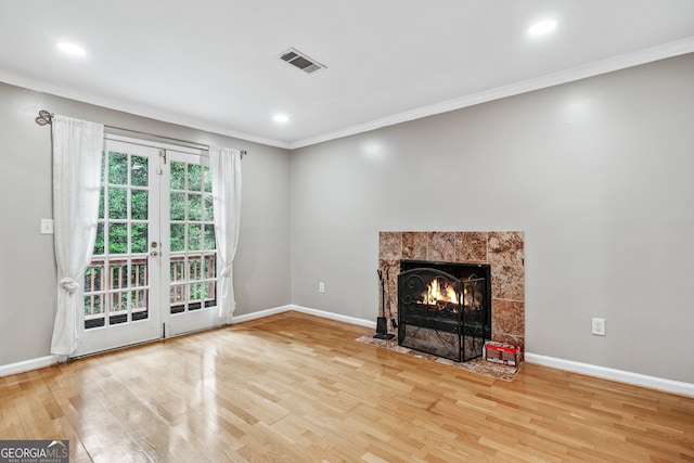 unfurnished living room with wood-type flooring and crown molding