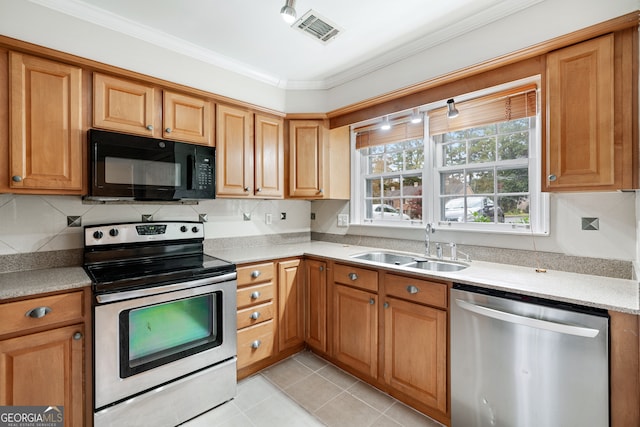 kitchen with stainless steel appliances, light tile patterned flooring, sink, tasteful backsplash, and crown molding