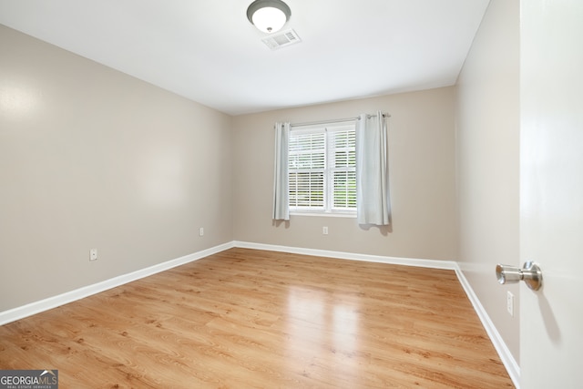 empty room with hardwood / wood-style flooring