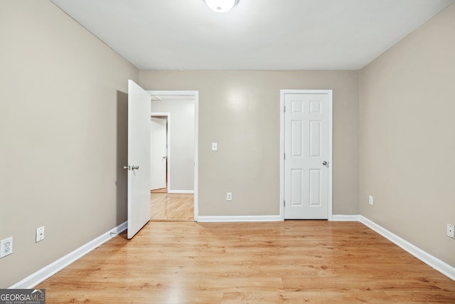 unfurnished bedroom with light wood-type flooring