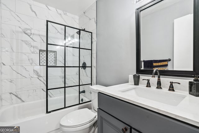 full bathroom featuring vanity, combined bath / shower with glass door, and toilet