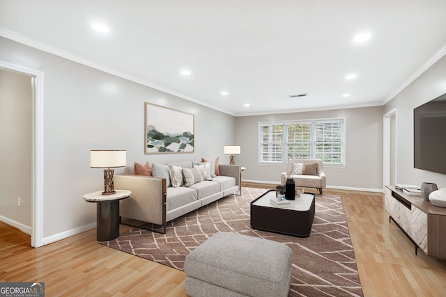 living room featuring ornamental molding and light hardwood / wood-style floors