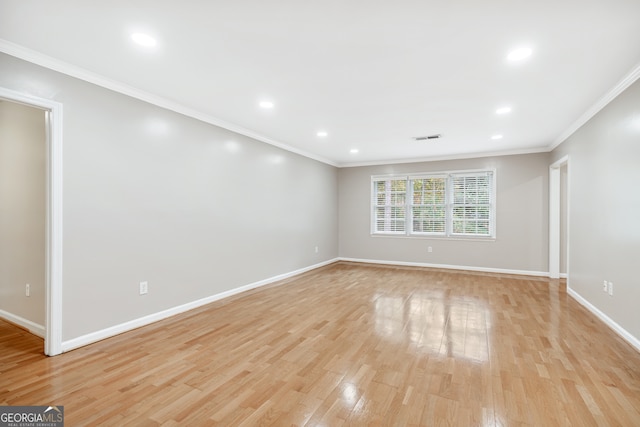 unfurnished room featuring light wood-type flooring and crown molding