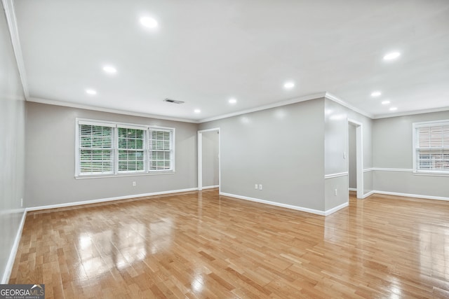 empty room featuring light hardwood / wood-style flooring and ornamental molding