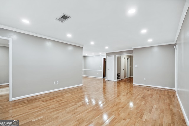 interior space with light hardwood / wood-style flooring and ornamental molding