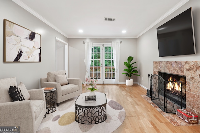 living room featuring ornamental molding, hardwood / wood-style floors, and french doors