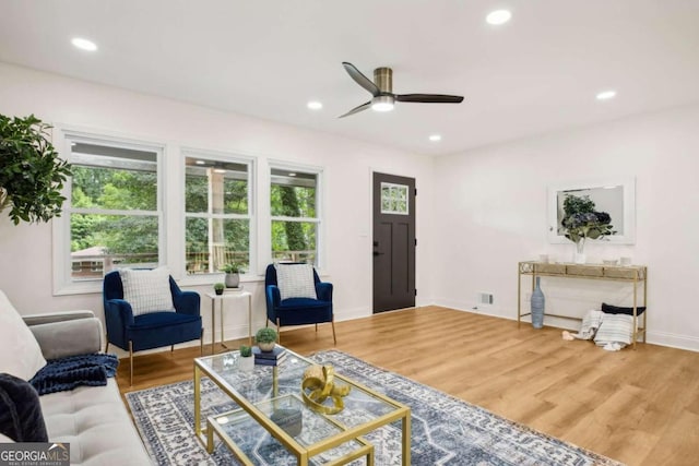 living room featuring hardwood / wood-style floors and ceiling fan