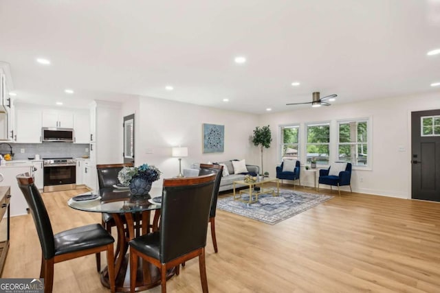 dining area featuring ceiling fan and light hardwood / wood-style flooring