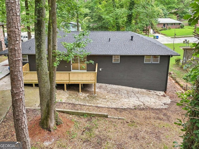 back of property featuring a deck