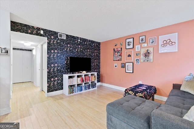 living room featuring hardwood / wood-style flooring and a textured ceiling