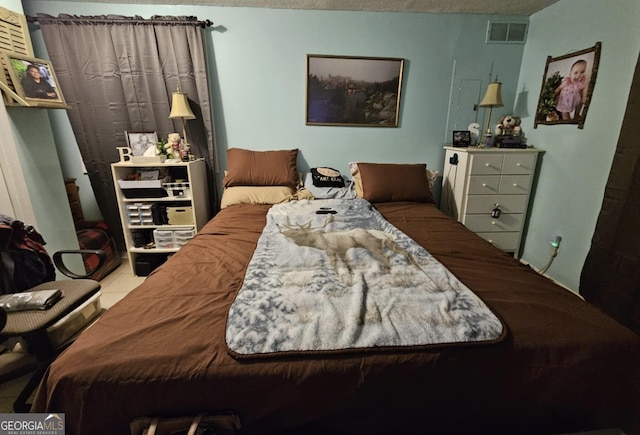 tiled bedroom featuring a textured ceiling