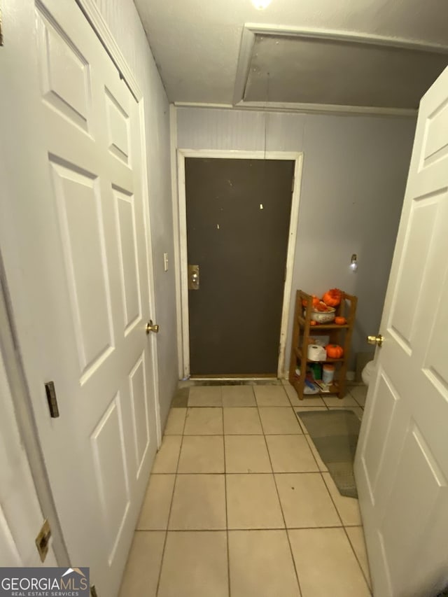 doorway to outside featuring light tile patterned flooring