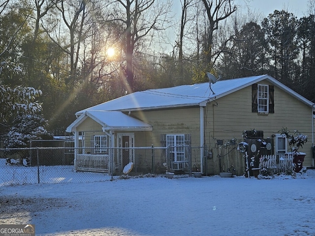 view of snow covered back of property