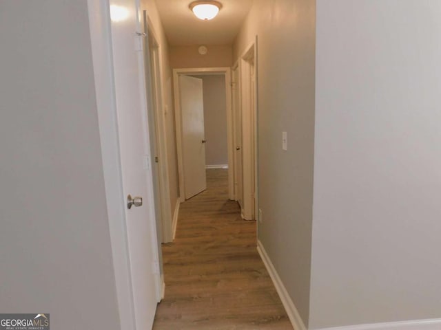 corridor with light hardwood / wood-style floors