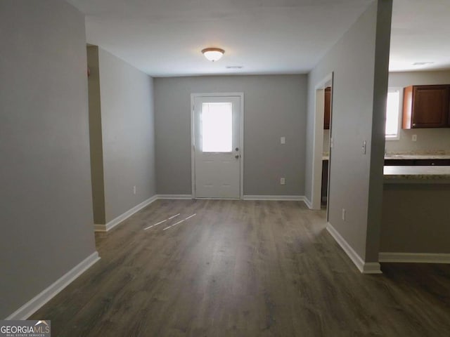 entryway with dark hardwood / wood-style flooring