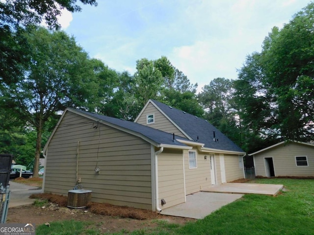 rear view of property featuring a patio and central air condition unit