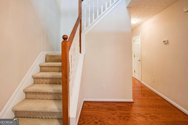 stairs featuring hardwood / wood-style flooring