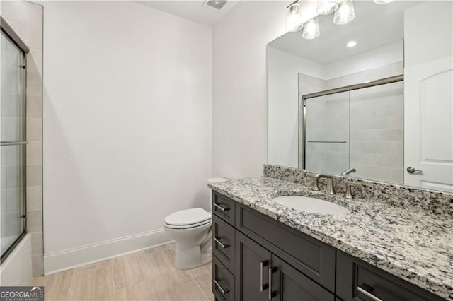 full bathroom with toilet, combined bath / shower with glass door, and vanity