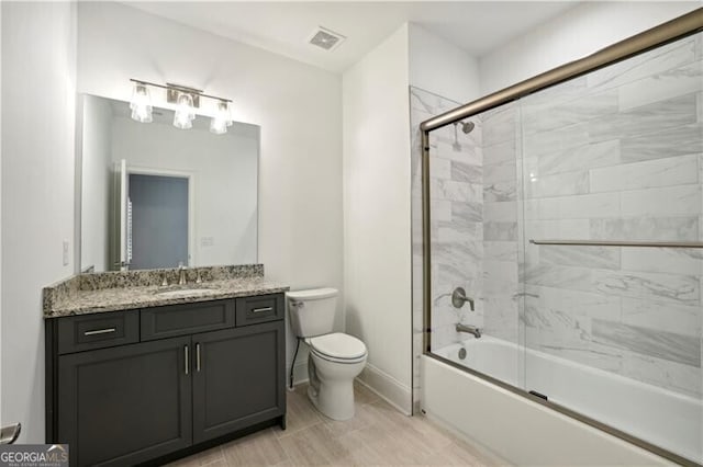 full bathroom with toilet, combined bath / shower with glass door, and vanity