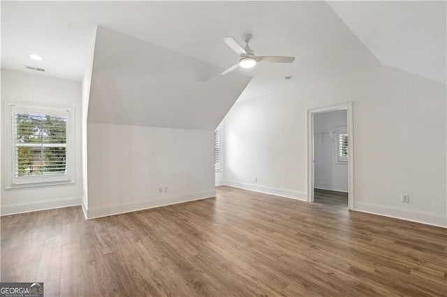 additional living space featuring ceiling fan, dark hardwood / wood-style floors, and vaulted ceiling