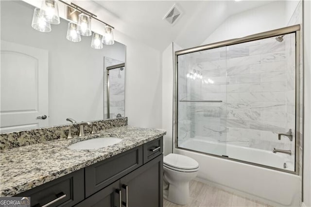 full bathroom with shower / bath combination with glass door, vanity, and toilet