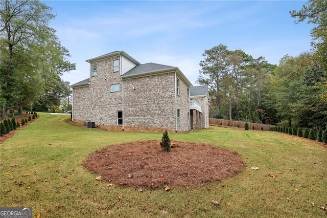 view of side of home featuring a lawn