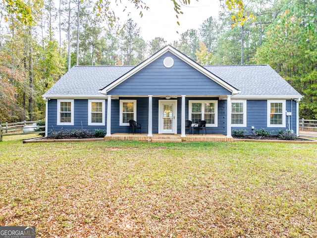 ranch-style home featuring a porch and a front lawn