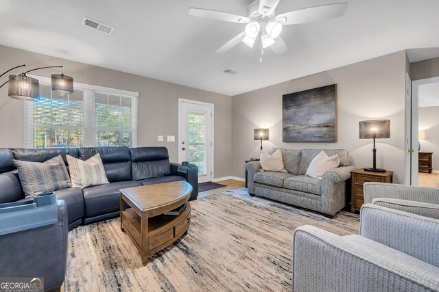 living room featuring light hardwood / wood-style floors and ceiling fan