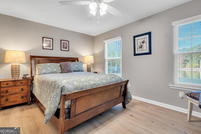 bedroom with light hardwood / wood-style flooring, multiple windows, and ceiling fan