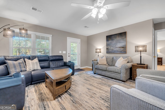 living room with ceiling fan and light wood-type flooring