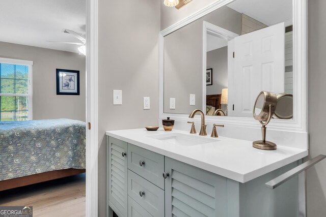 bathroom featuring wood-type flooring, vanity, and ceiling fan