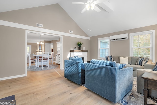 living room with a wall unit AC, high vaulted ceiling, ceiling fan with notable chandelier, and hardwood / wood-style flooring