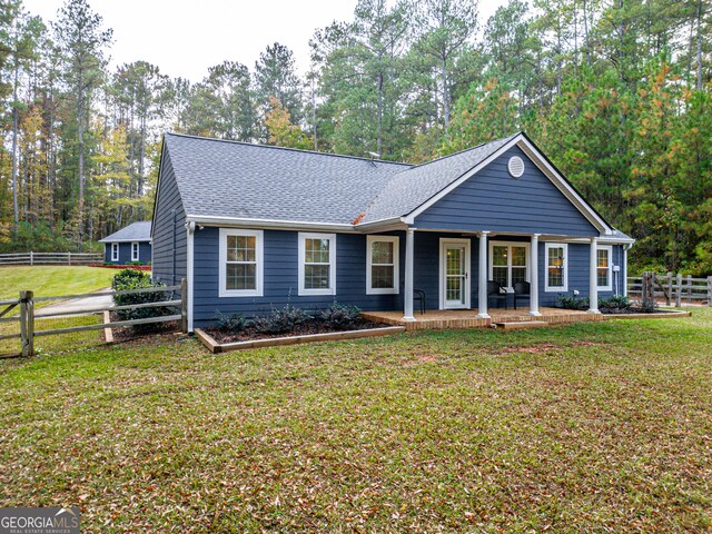 ranch-style house with a front yard and a porch