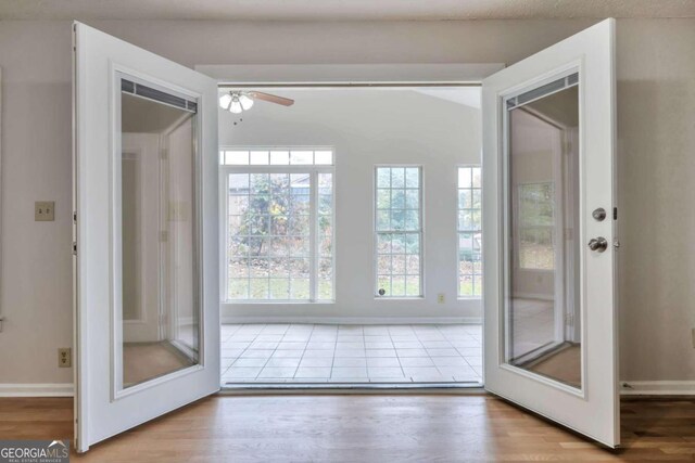 doorway to outside featuring hardwood / wood-style flooring and ceiling fan