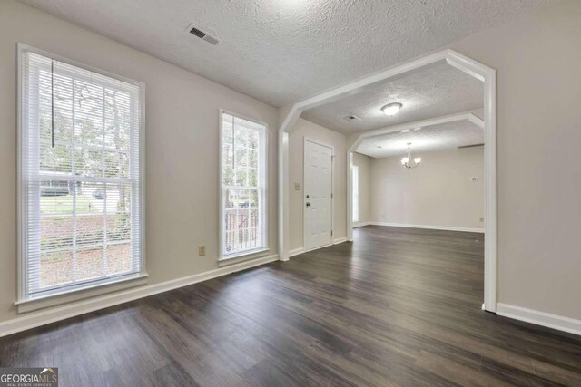 entrance foyer with a healthy amount of sunlight and dark hardwood / wood-style floors