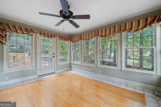 unfurnished sunroom with plenty of natural light and ceiling fan