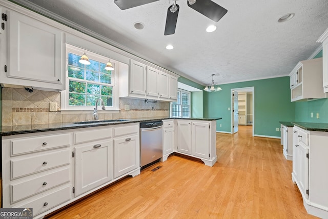 kitchen featuring white cabinets, kitchen peninsula, sink, stainless steel dishwasher, and light wood-type flooring