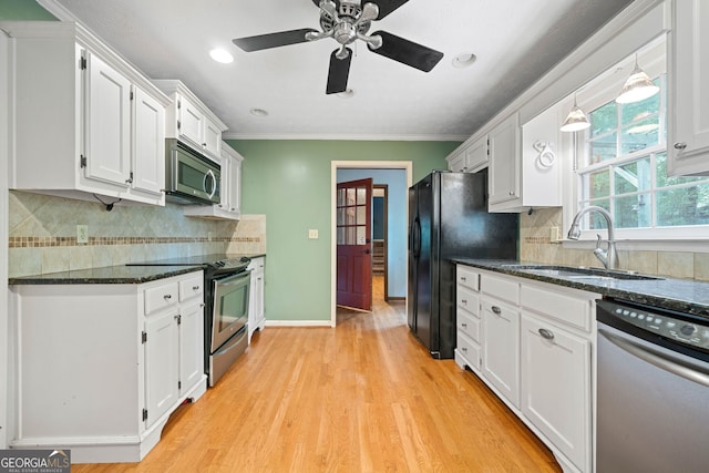 kitchen featuring stainless steel appliances, white cabinets, and sink